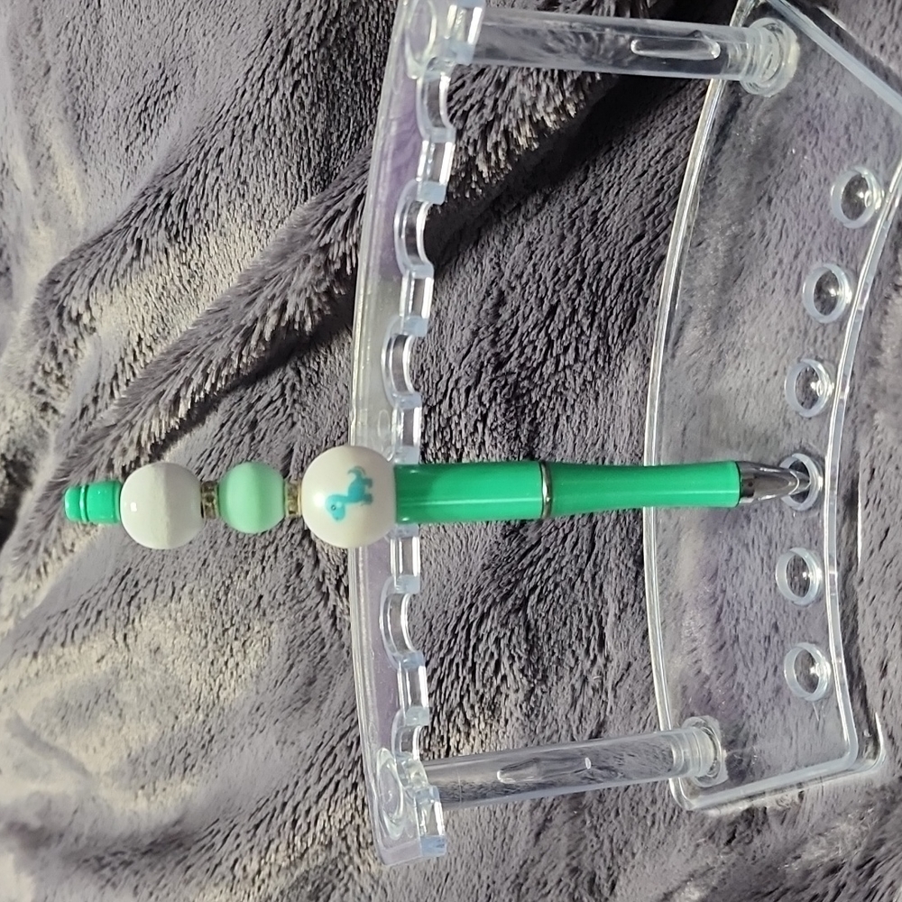 Handmade decorative Dinosaur beaded pen. Includes pouch.